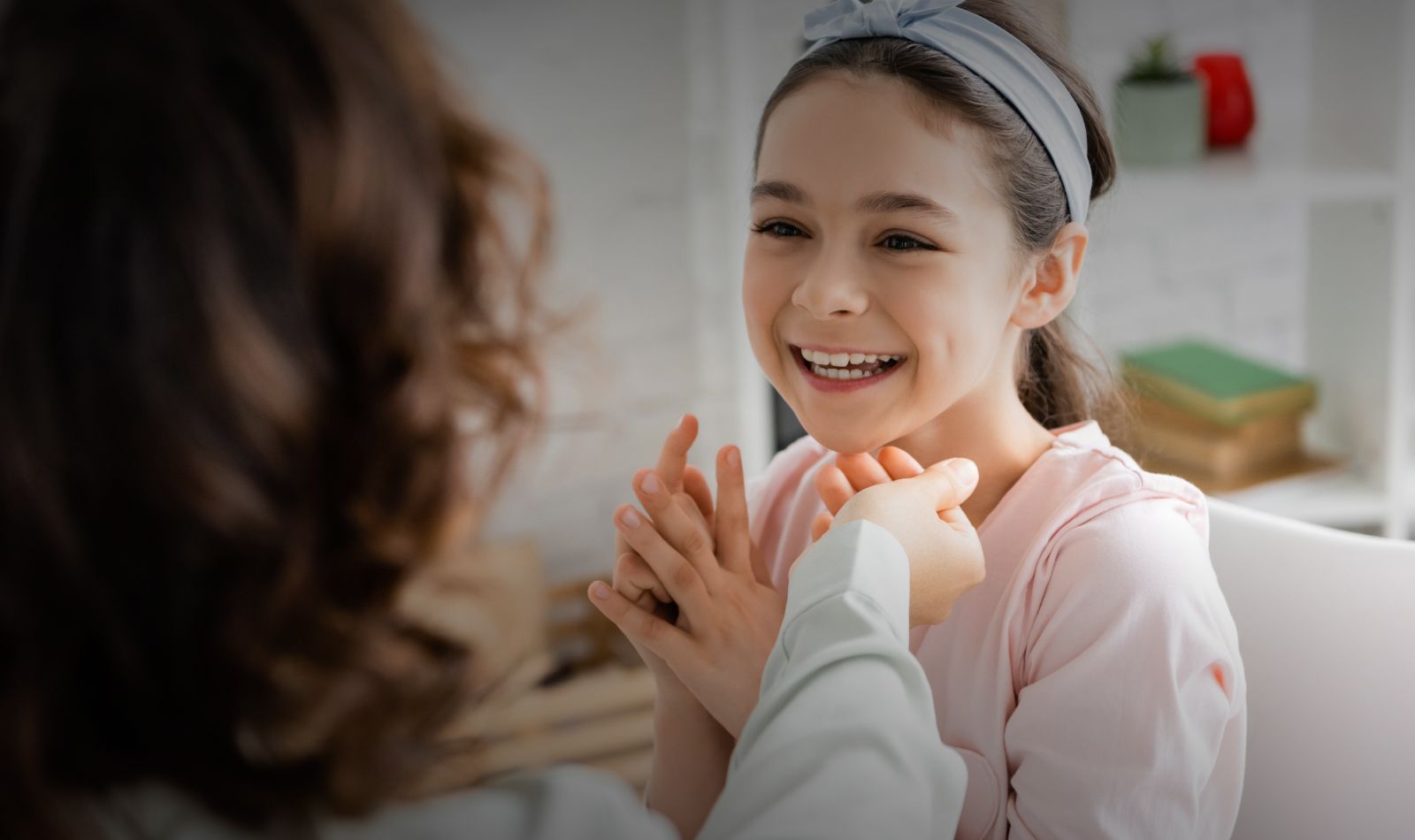 Smiling child enjoying a caring moment.